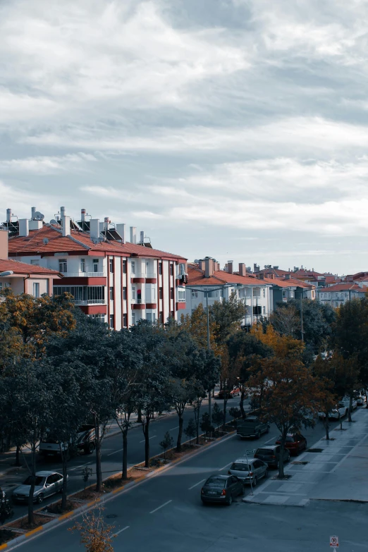 a city street filled with lots of tall buildings, inspired by Yasar Vurdem, unsplash contest winner, modernism, arrendajo in avila pinewood, red roofs, cinematic composition 8 k, turkey