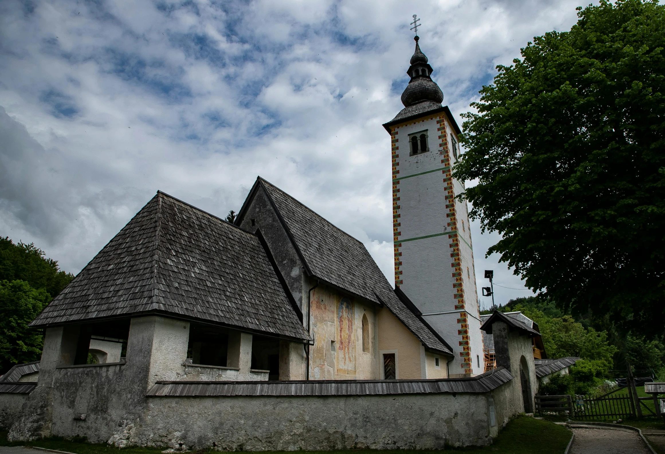 a church with a steeple and a clock tower, inspired by Károly Markó the Elder, pexels contest winner, romanesque, kilart, exterior photo, slovenian, thumbnail