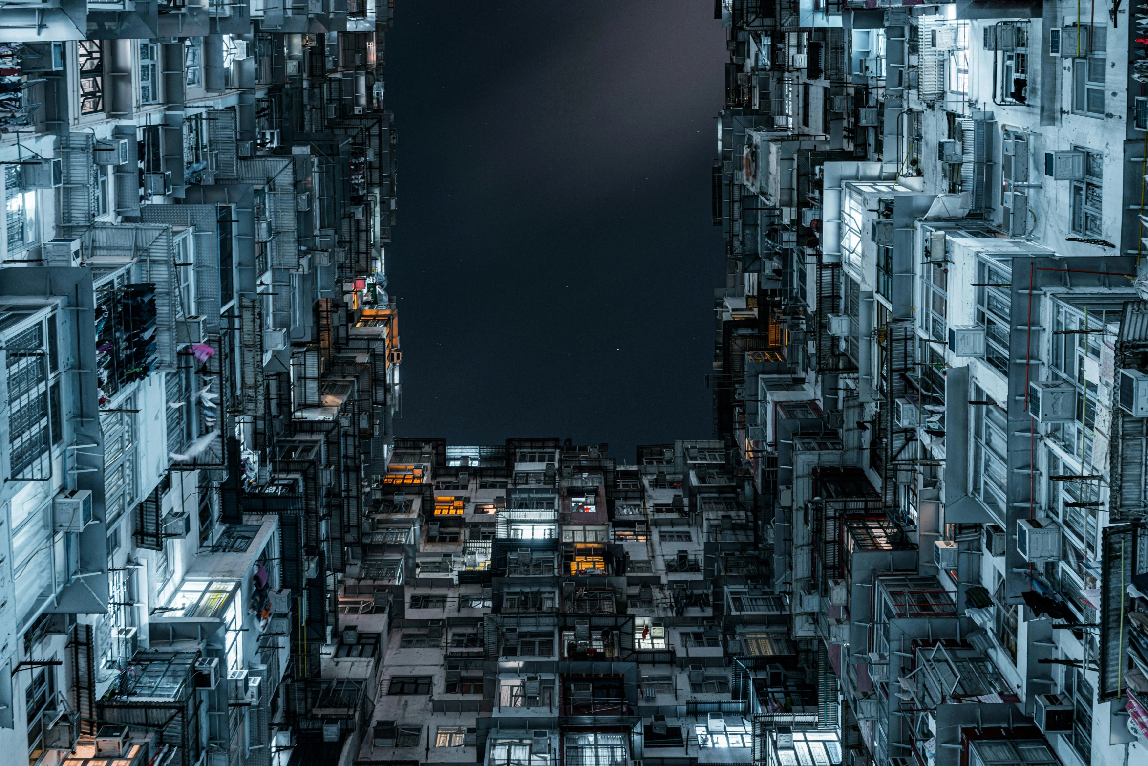 a very tall building with lots of windows, inspired by Beeple, unsplash contest winner, modular constructivism, kowloon walled city, nighttime, istock, greeble