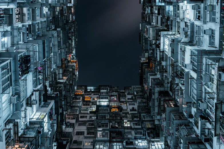 a very tall building with lots of windows, inspired by Beeple, unsplash contest winner, modular constructivism, kowloon walled city, nighttime, istock, greeble