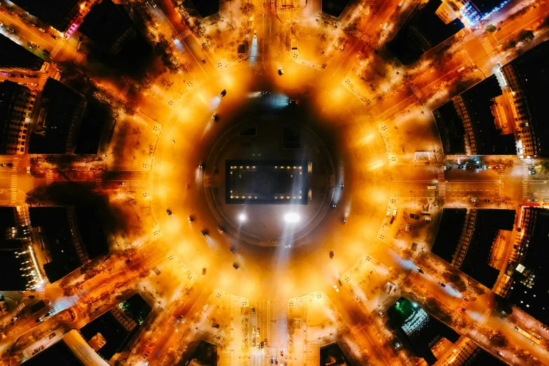 an aerial view of a city at night, an album cover, by Joe Bowler, pexels contest winner, conceptual art, orange halo, the masjid al-haram in mecca, extreme close shot, radial light