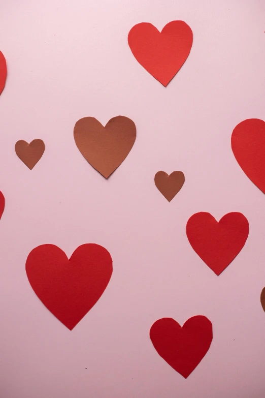 a bunch of red and brown hearts on a pink background, trending on pexels, portrait photo of a backdrop, dating app icon, hot topic, u