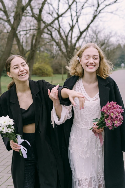 a couple of women standing next to each other, happening, carrying flowers, post graduate, in style of petra collins, excited russians