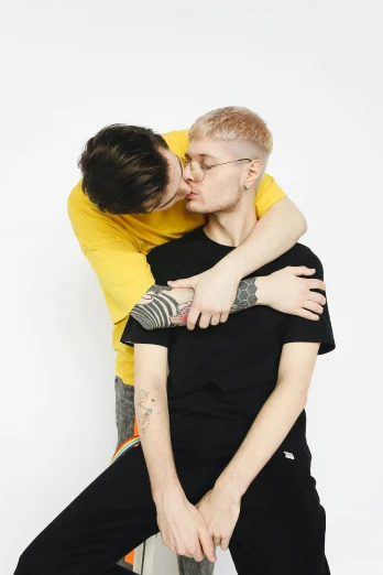 a couple of people that are hugging each other, an album cover, unsplash, antipodeans, non binary model, plain background, high quality photo, smooggy