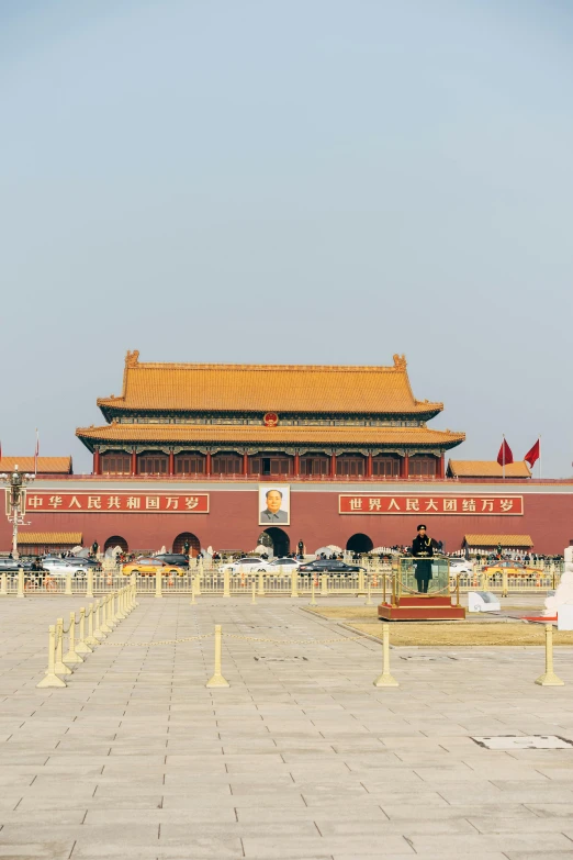 a man that is standing in front of a building, inspired by Ai Weiwei, trending on unsplash, tiananmen square, panoramic shot, huge gate, color image