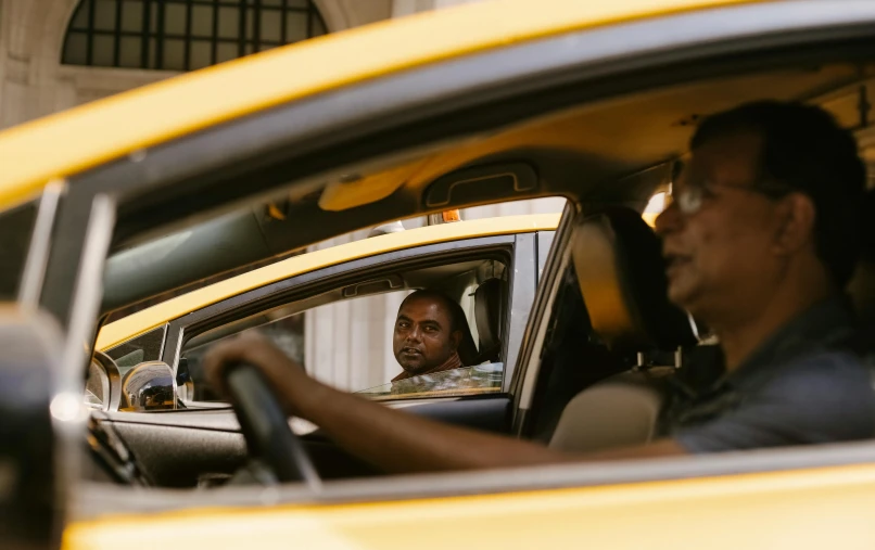 a man sitting in the driver's seat of a taxi, a photo, square, jemal shabazz, rodney matthew, inside a grand