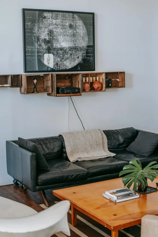 a living room filled with furniture and a flat screen tv, by Washington Allston, unsplash, light and space, sitting on vintage leather sofa, dwell, satisfying cable management, bay area