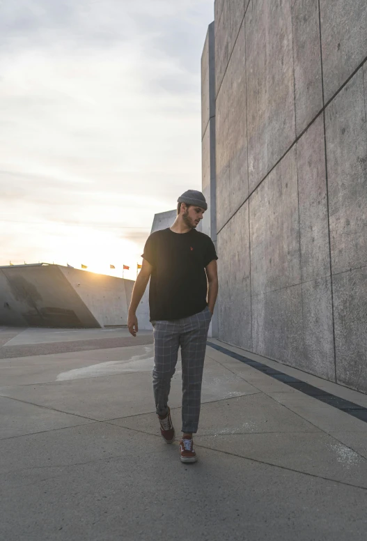 a man riding a skateboard down a sidewalk, a picture, pexels contest winner, looking off into the sunset, grey pants and black dress shoes, on a large marble wall, daniel ricciardo