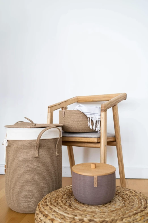 a chair sitting on top of a wooden floor next to a basket, a picture, japanese collection product, lumi, product introduction photo, laundry hanging