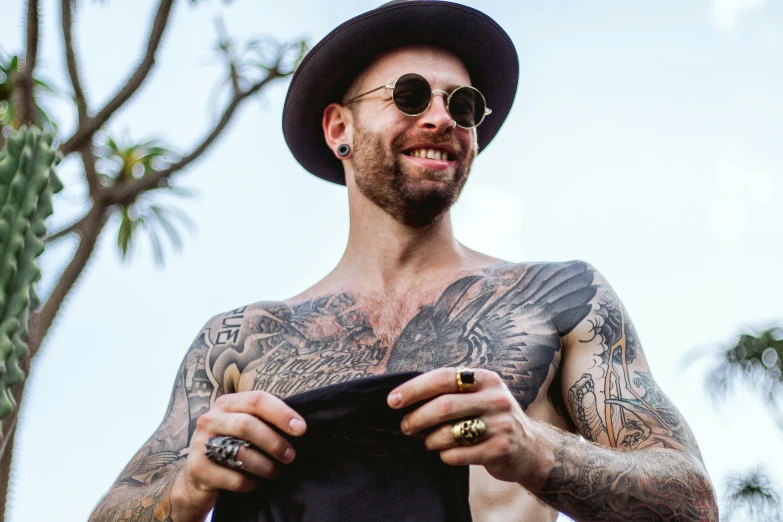 a man that has some tattoos on his chest, inspired by Seb McKinnon, pexels contest winner, tipping his fedora, brett goldstein, avatar image, australian