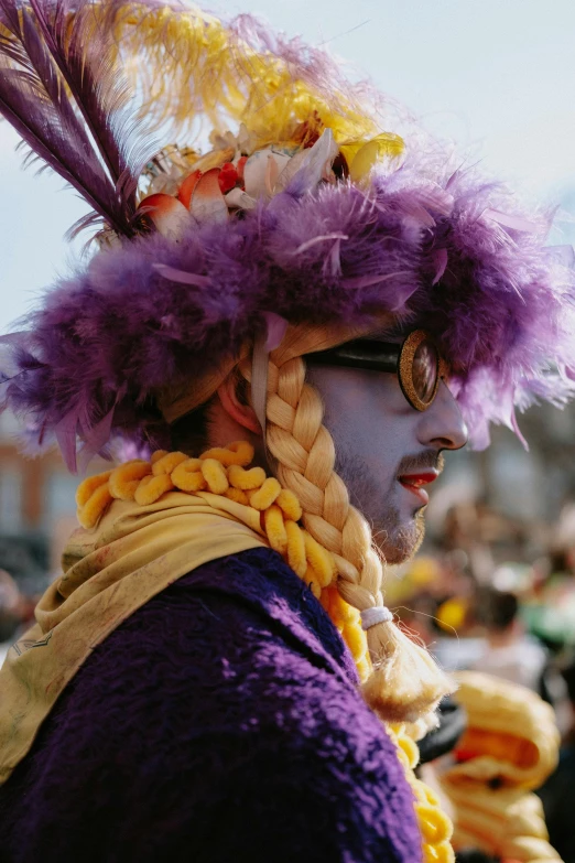 a close up of a person wearing a costume, inspired by Bernd Fasching, renaissance, purple and yellow, parade, slightly sunny, album