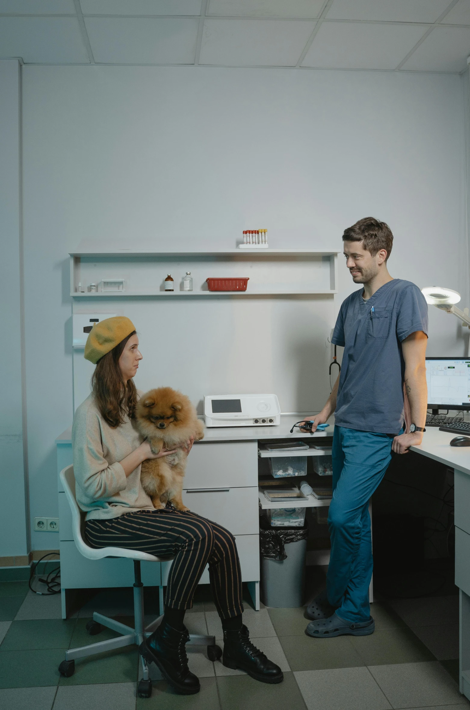 a man standing next to a woman sitting at a desk, by Adam Marczyński, trending on reddit, small dog, diagnostics, studio photo, ikea