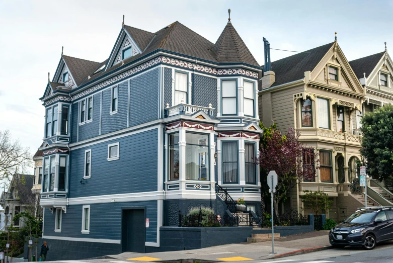 a blue house sitting on the corner of a street, a photo, by Meredith Dillman, unsplash, art nouveau, bay area, ignant, a cozy old victorian loft, zig zag