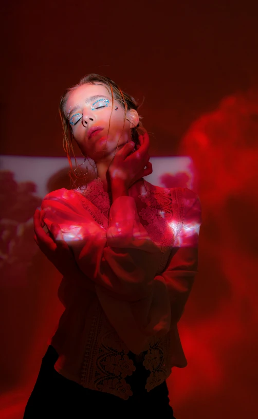 a woman standing in front of a red light, an album cover, pexels, holography, red cloud light, showstudio, model posing, joel fletcher