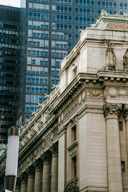 a clock that is on the side of a building, by Greg Rutkowski, pexels contest winner, neoclassicism, new york buildings, grand library, seen from a distance, high details photo