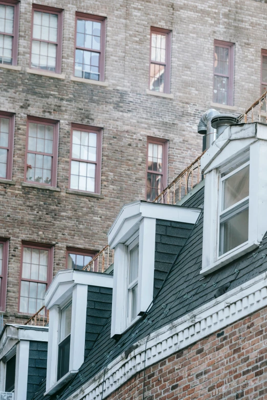 a clock mounted to the side of a brick building, by Nina Hamnett, trending on unsplash, hiding in the rooftops, in savannah, view from back, tenement buildings