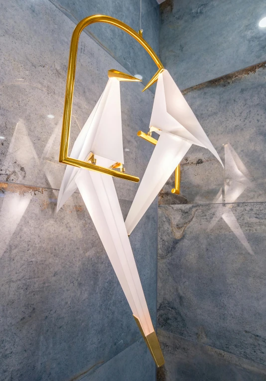 a white umbrella hanging from the side of a shower, an abstract sculpture, by Giuseppe Avanzi, kinetic art, cranes, golden lighting, origami, promo image