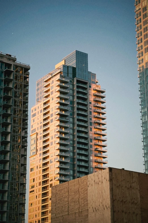 a couple of tall buildings sitting next to each other, a picture, by Doug Ohlson, unsplash, modernism, late afternoon light, british columbia, low quality photo, multiple stories