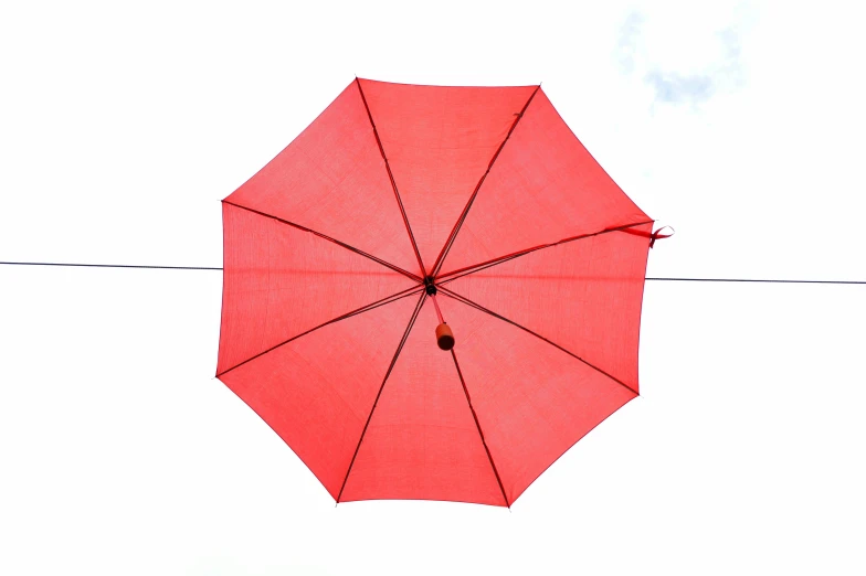 a red umbrella hanging from a clothes line, inspired by Louise Bourgeois, unsplash, looking up onto the sky, high - angle view, martin parr, with a white background