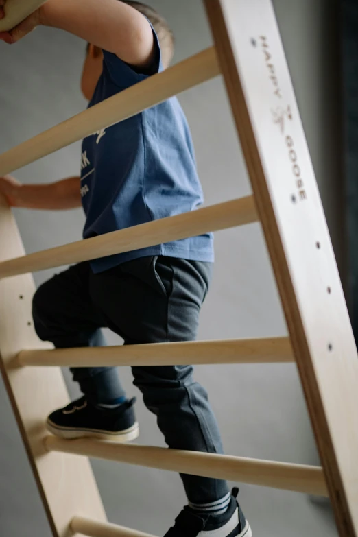 a little boy standing on top of a wooden ladder, unsplash, mingei, activity play centre, standing in corner of room, high-body detail, lightweight