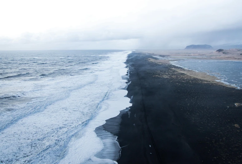 a large body of water next to a beach, by Hallsteinn Sigurðsson, pexels contest winner, hurufiyya, ferrofluid oceans, death vally, black road, half and half