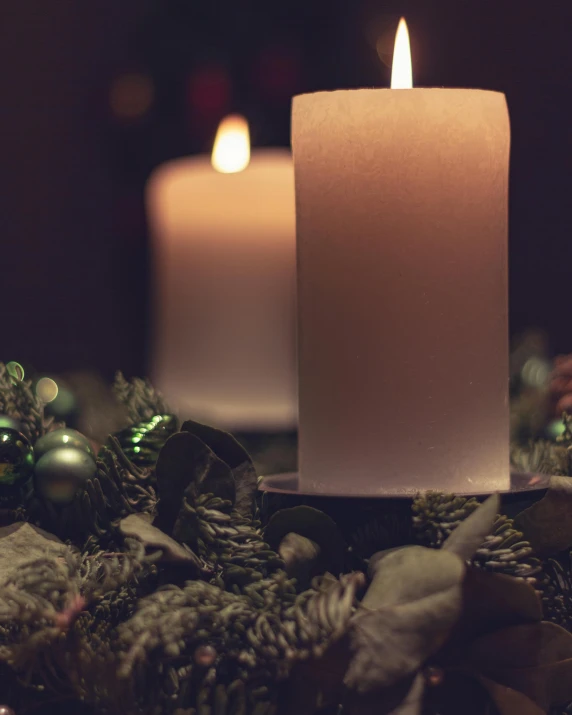 a lit candle sitting on top of a christmas wreath, trending on unsplash, romanticism, multiple stories, dark. no text, lgbtq, profile image