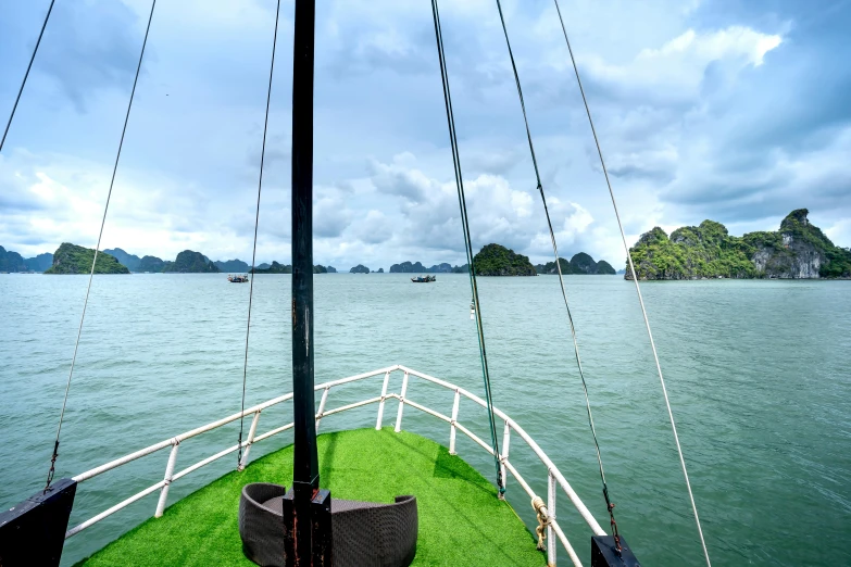 a view of a body of water from a boat, by Sven Erixson, pexels contest winner, hoang long ly, lush green, limestone, fan favorite