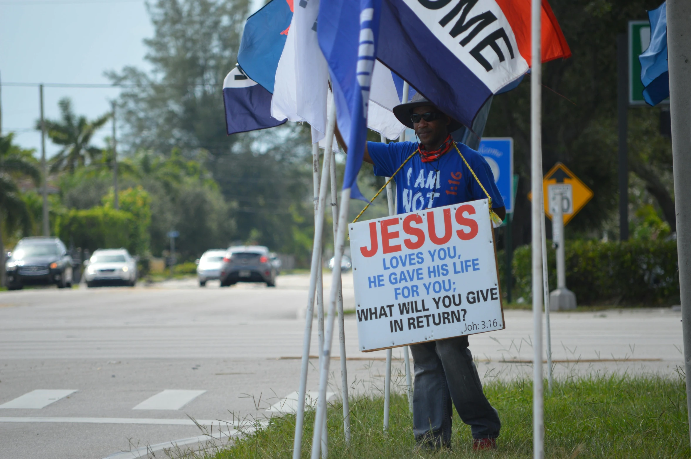 a man holding a sign on the side of the road, a photo, florida man, cloth banners, jesus face, thumbnail