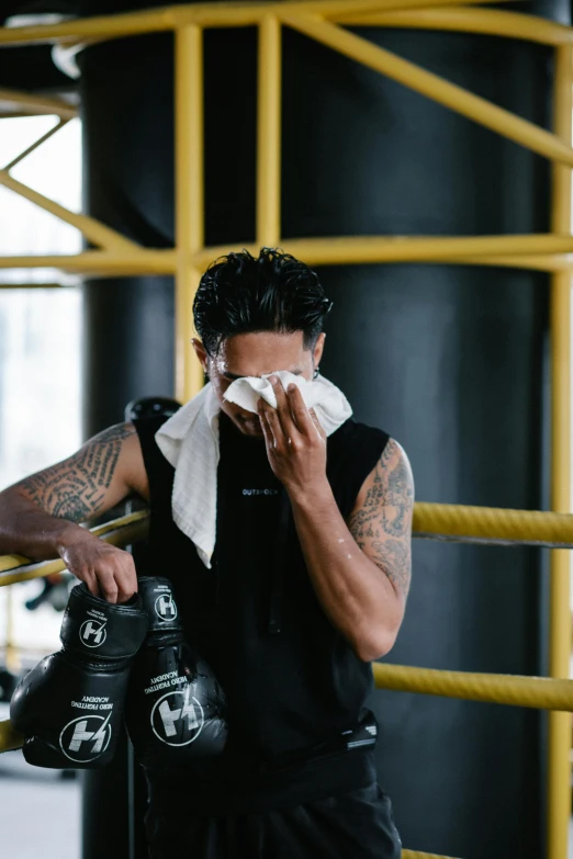 a man wiping his face in a boxing ring, hydration, with cry engine, super buff and cool, thawan duchanee