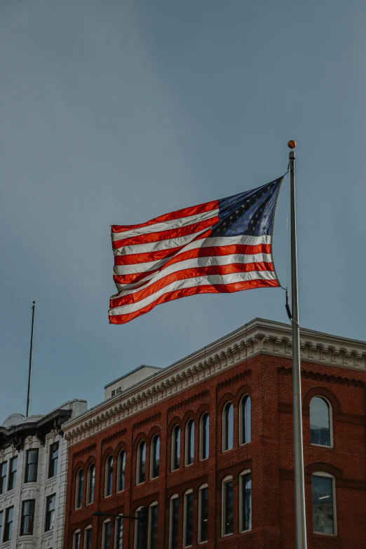 an american flag flying in front of a building