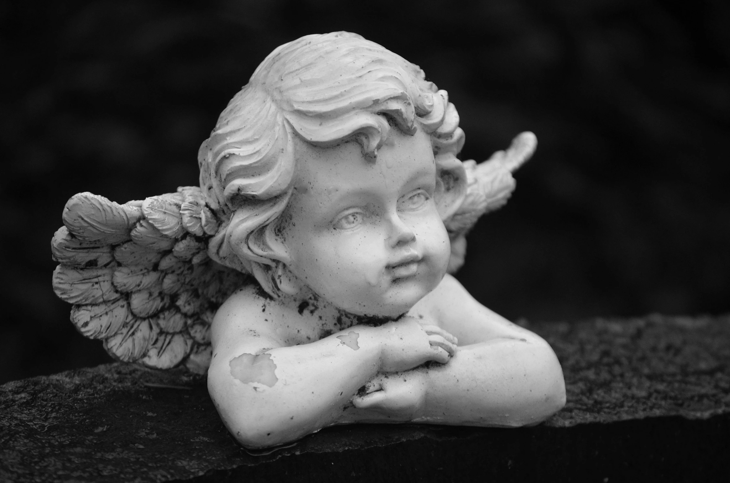a black and white photo of a statue of an angel, pixabay contest winner, closeup of an adorable, beautiful detailed miniature, dead child, slightly smiling
