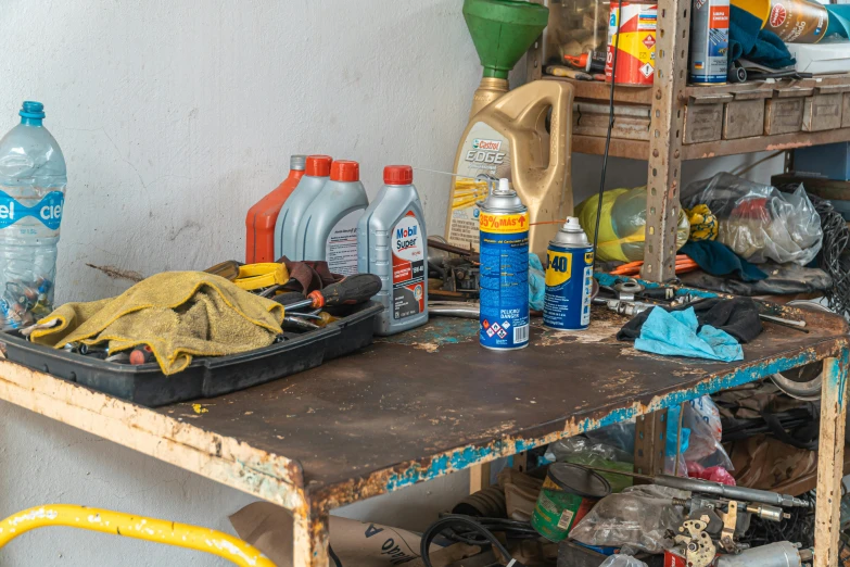 a table that has a bunch of items on it, arbeitsrat für kunst, an octopus in a car repair shop, portrait image, chemicals, maintenance photo