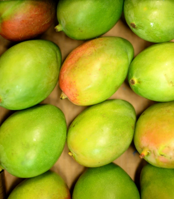 a box filled with lots of green and yellow mangoes, by Emanuel Witz, pexels, hurufiyya, high detailed close up of, 2 5 6 x 2 5 6 pixels, reggae, magnificent oval face