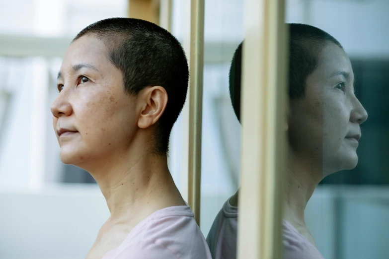 a couple of women standing next to each other, an album cover, inspired by Lin Tinggui, pexels contest winner, hyperrealism, shaved head, looking out of the window, profile image, older woman