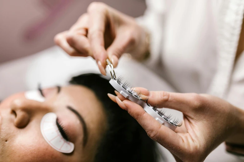 a woman getting her eyebrows done at a beauty salon, trending on pexels, crown of (white lasers), fan favorite, manuka, “ painting