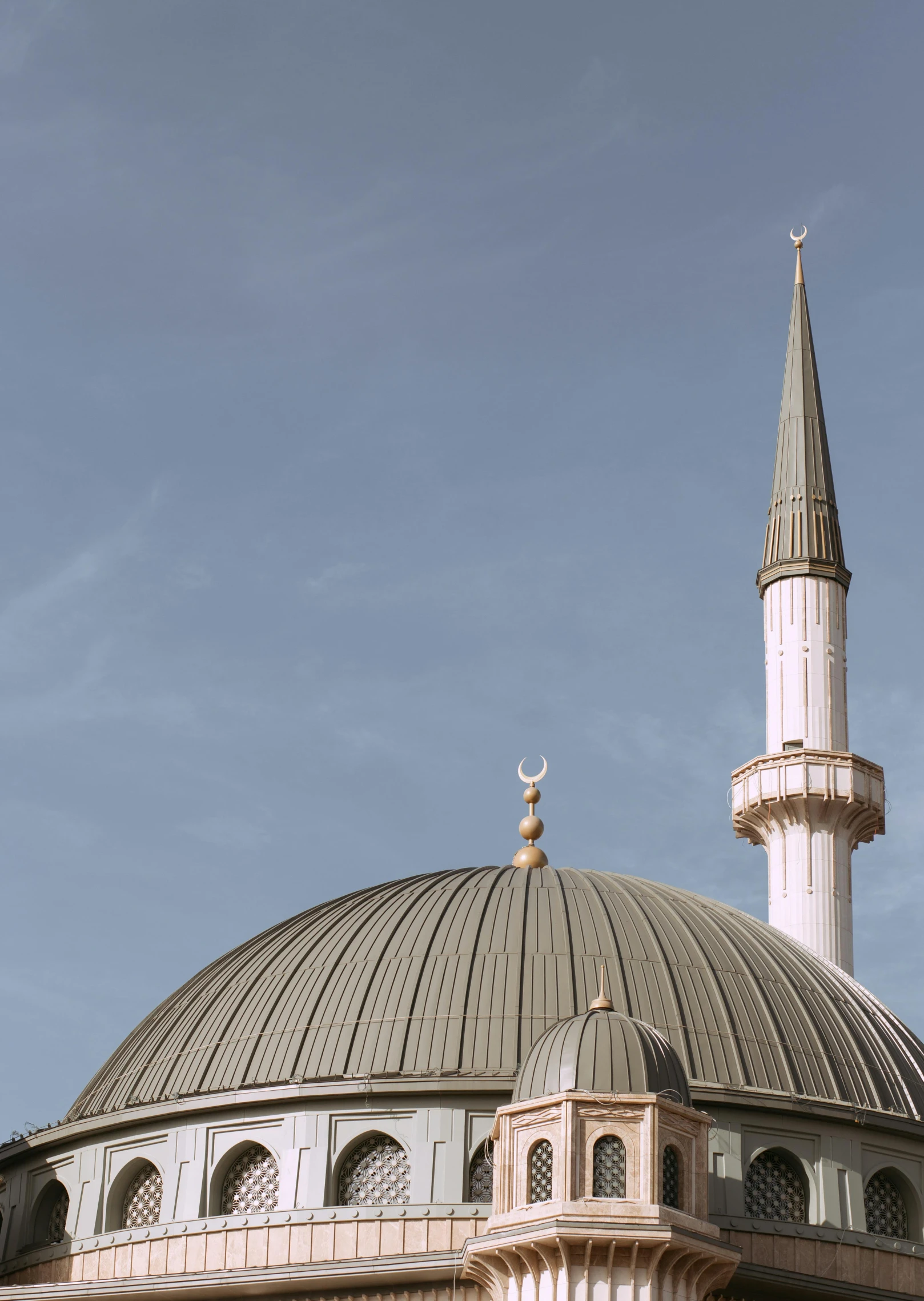 a large building with a clock on top of it, hurufiyya, lead - covered spire, 2022 photograph, **cinematic, pastel'