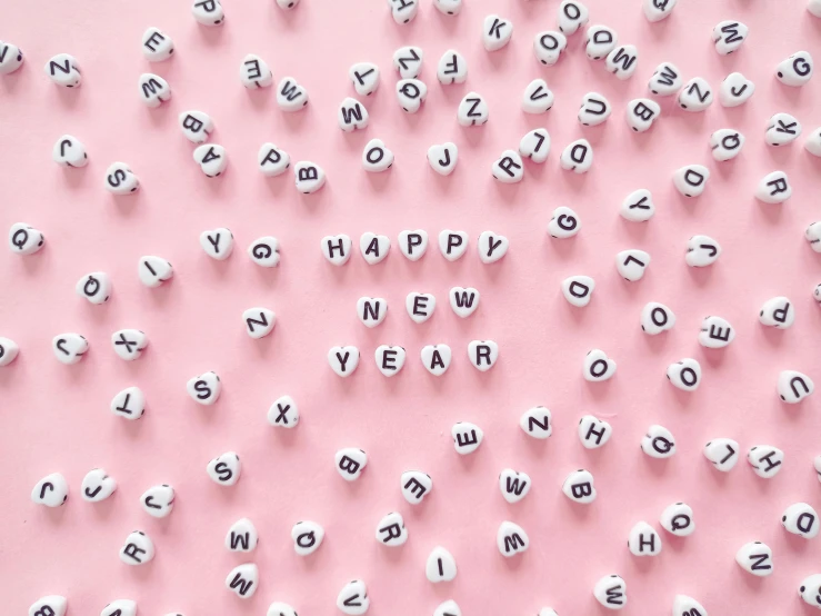 letters spelling happy new year on a pink background, trending on pexels, letterism, planner stickers, hygge, beads, julian ope