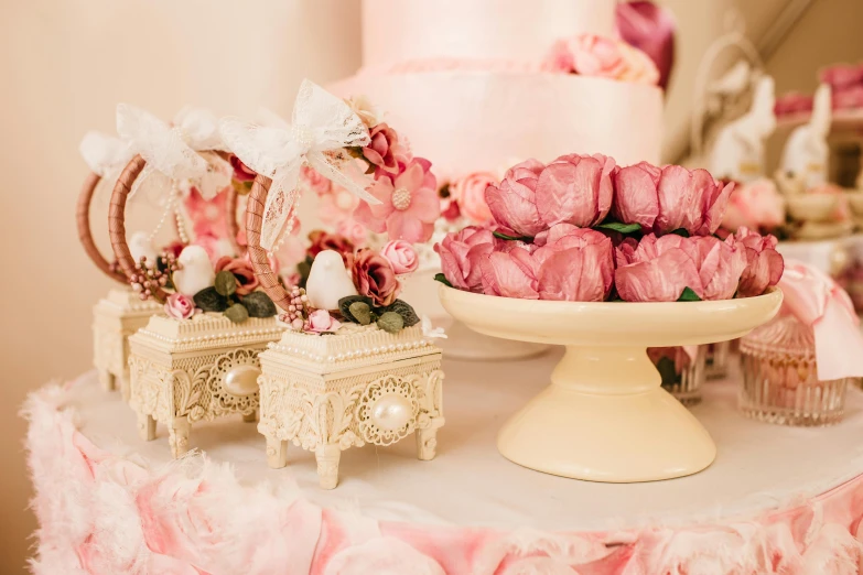 a table topped with a cake covered in pink roses, by Alice Mason, unsplash, rococo, candy decorations, closeup - view, cakes, antique style