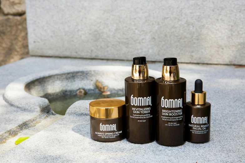 a couple of bottles sitting next to a fountain, inspired by Sōami, featured on instagram, smooth gold skin, nomad, made of smooth black goo, bombshell