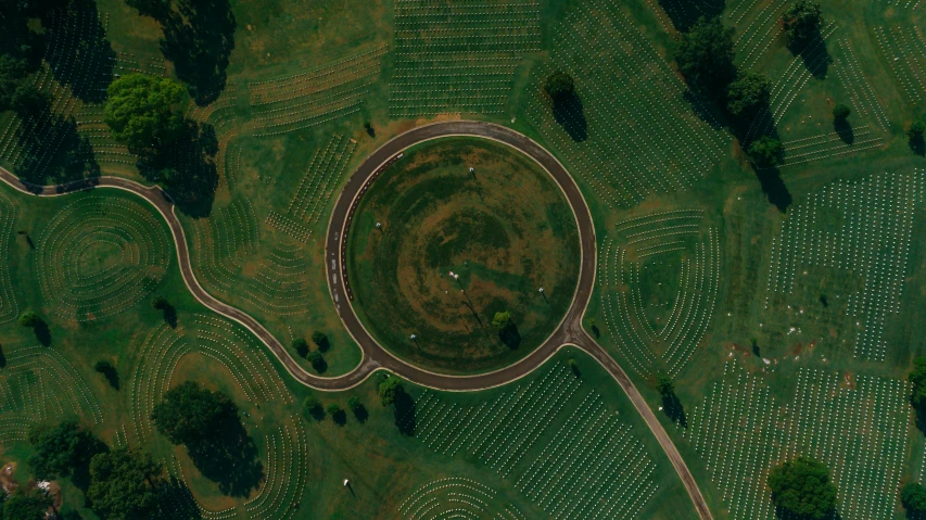 an aerial view of a circle in the middle of a field, by Attila Meszlenyi, unsplash contest winner, land art, giant tomb structures, augusta national, in a large grassy green field, digital rendering