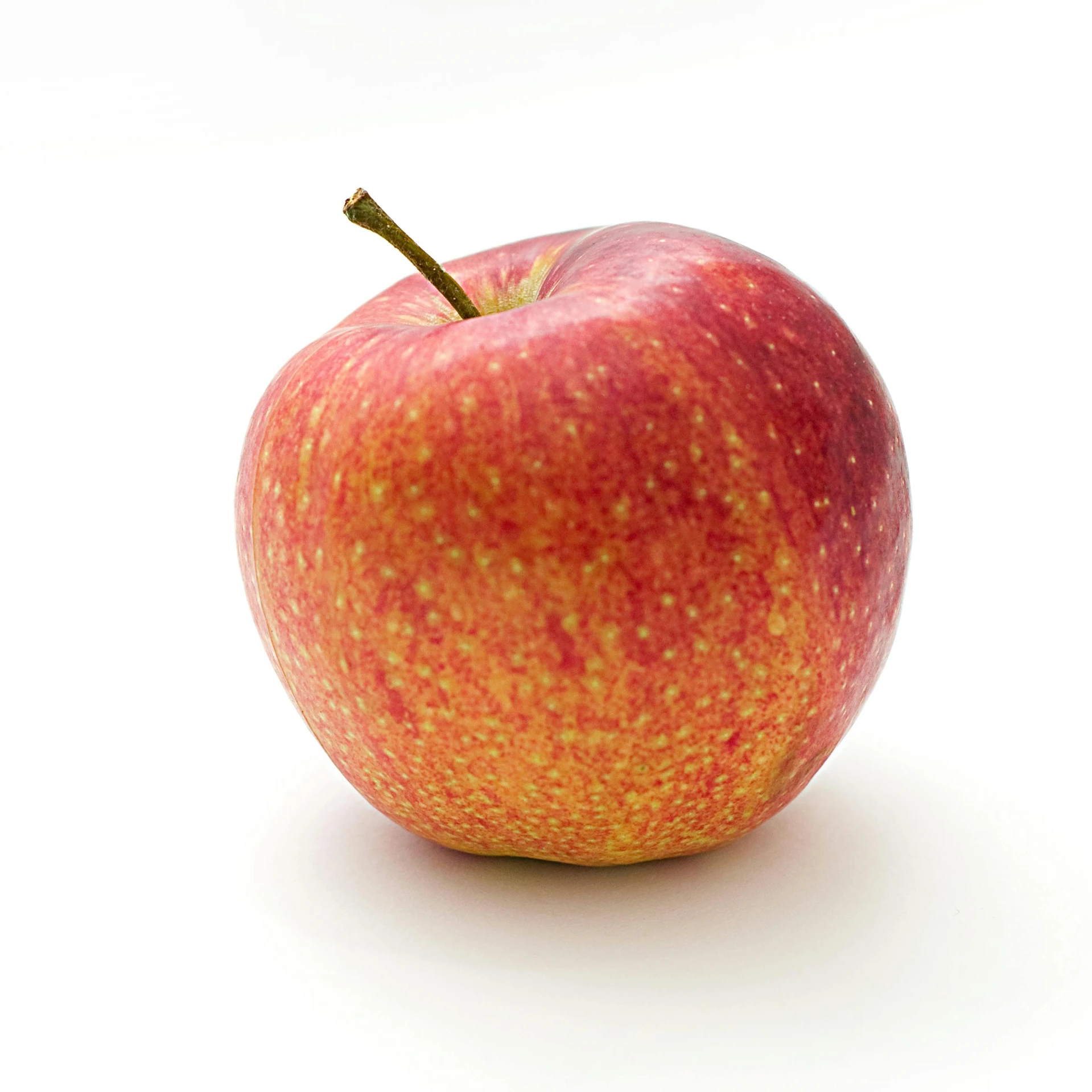 a red apple sitting on top of a white surface, official product photo, multicoloured, ready to eat, australian