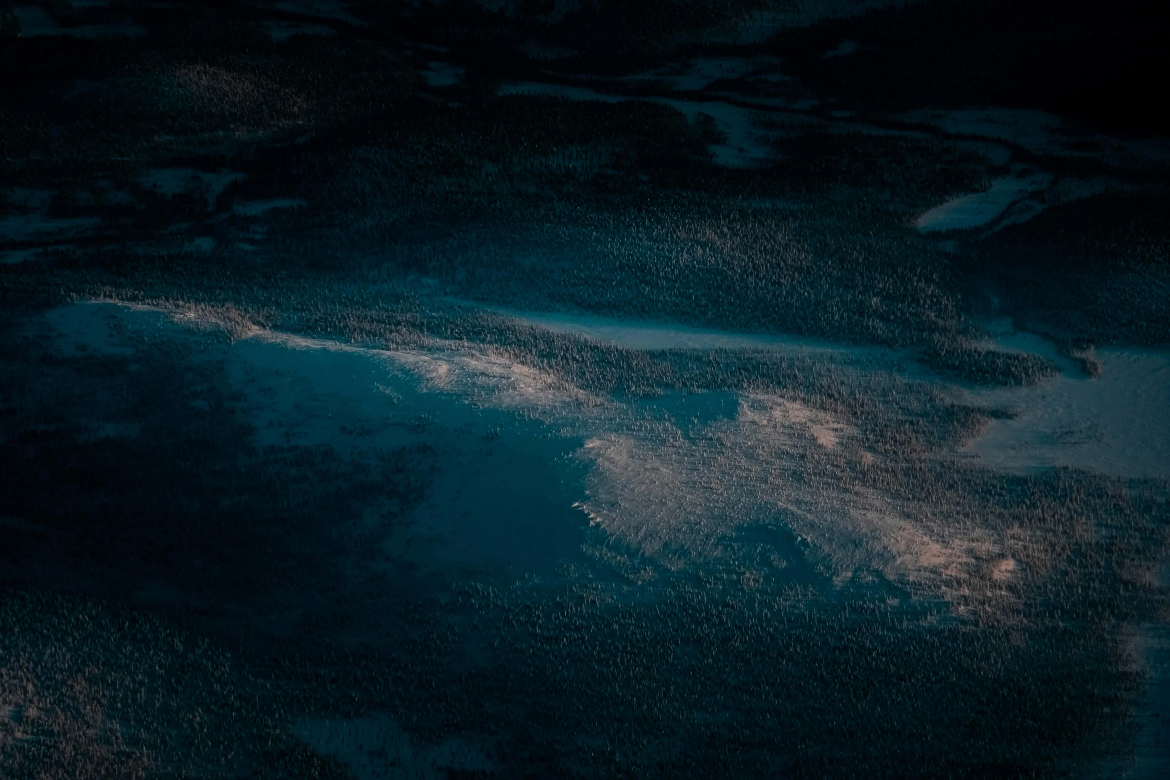 a man riding a snowboard on top of a snow covered slope, a microscopic photo, inspired by Filip Hodas, unsplash contest winner, tonalism, dark blue water, seen from a plane, (night), magicavoxel cinematic lighting