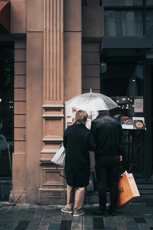 a couple of people that are standing in the rain, by Daniel Seghers, pexels contest winner, visual art, stood outside a corner shop, in chippendale sydney, gif, gothic quarter