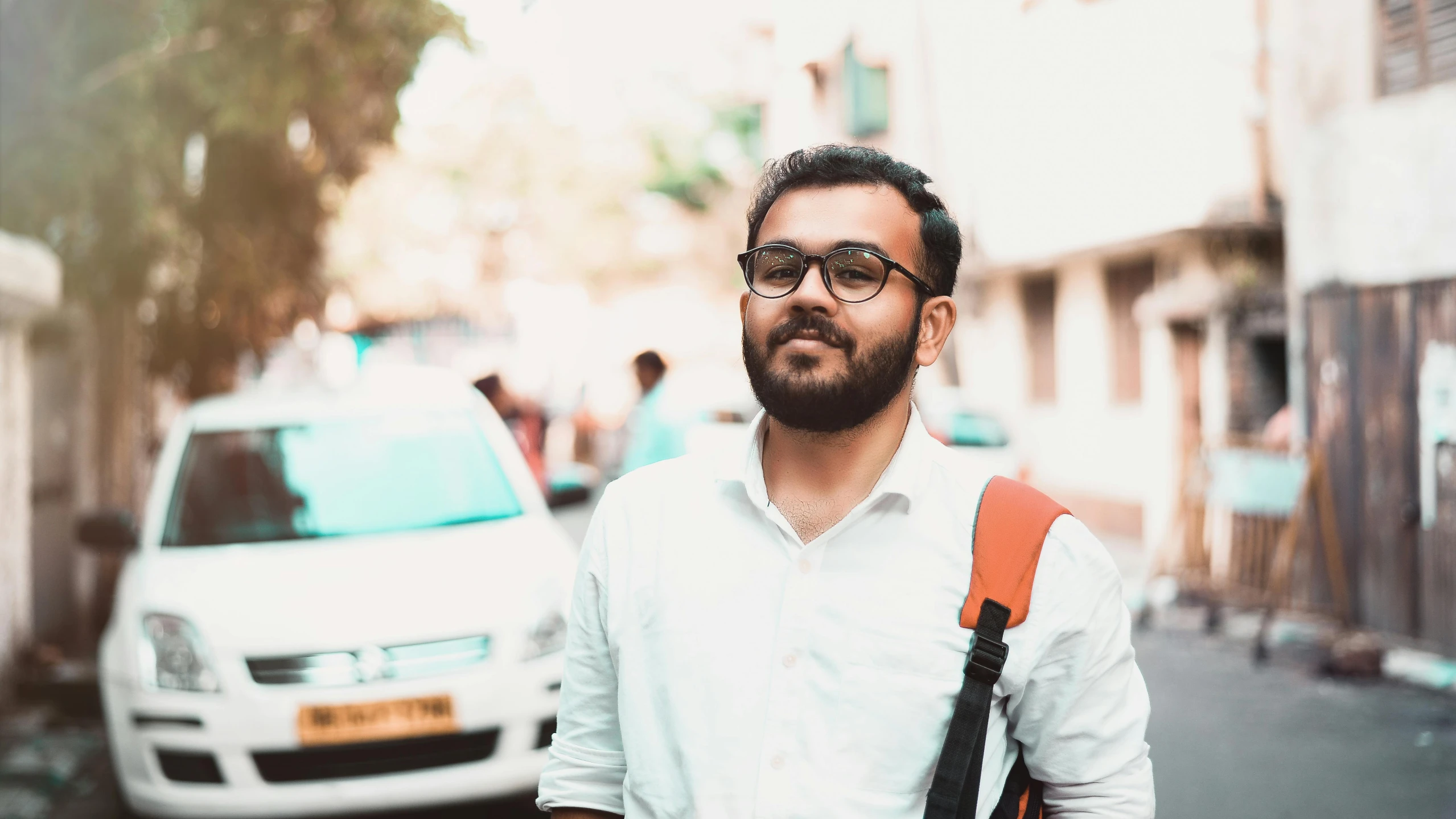 a man standing in the middle of a street, pexels contest winner, samikshavad, halfbody headshot, profile pic, with a small beard, avatar image