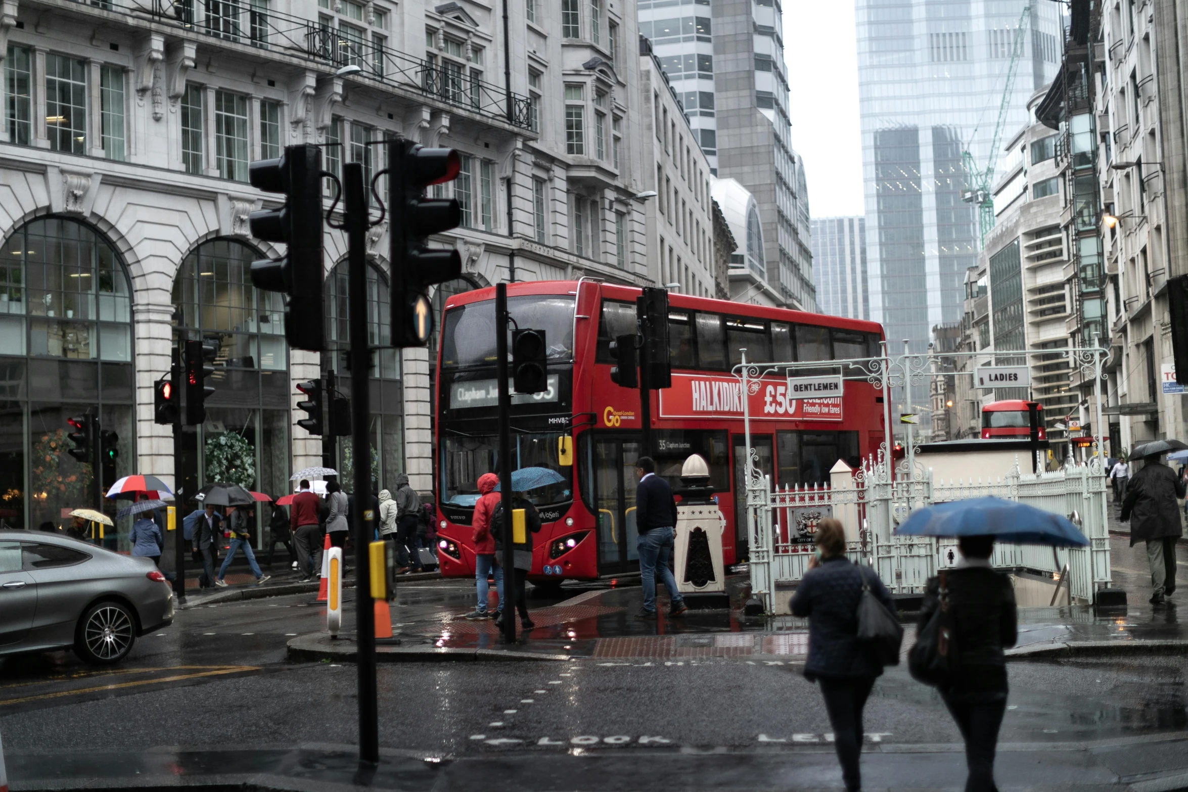 a red double decker bus driving down a city street, by Dave Allsop, pexels contest winner, grey skies rain, square, gif, ap