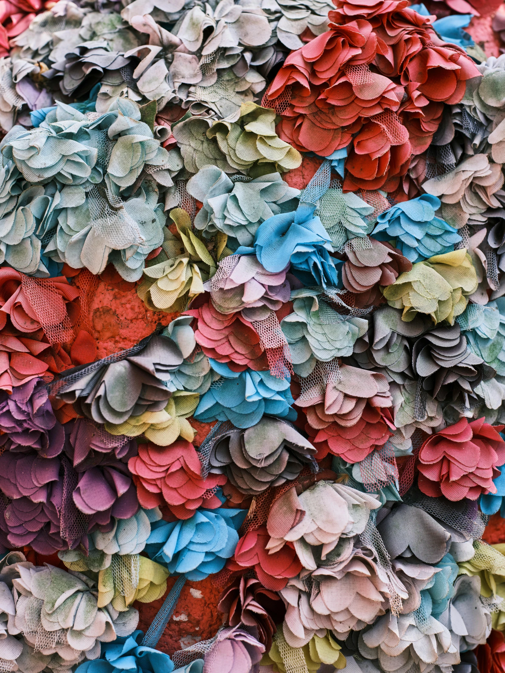 a pile of paper flowers sitting on top of a table, an album cover, inspired by John Chamberlain, trending on unsplash, detail texture, textured like a carpet, crowds, multicolor