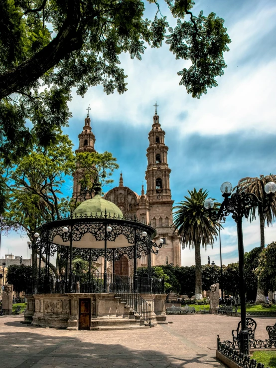 a gazebo sitting in the middle of a park, inspired by Luis Paret y Alcazar, pexels contest winner, quito school, black domes and spires, with palm trees and columns, 2 5 6 x 2 5 6 pixels, in the middle of the city