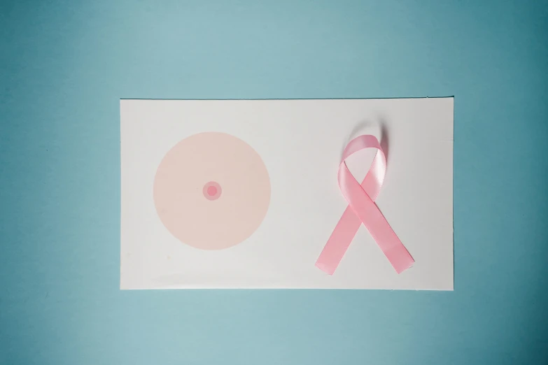 a pink ribbon sitting on top of a piece of paper, circle, sie boob, graphic print, digital image