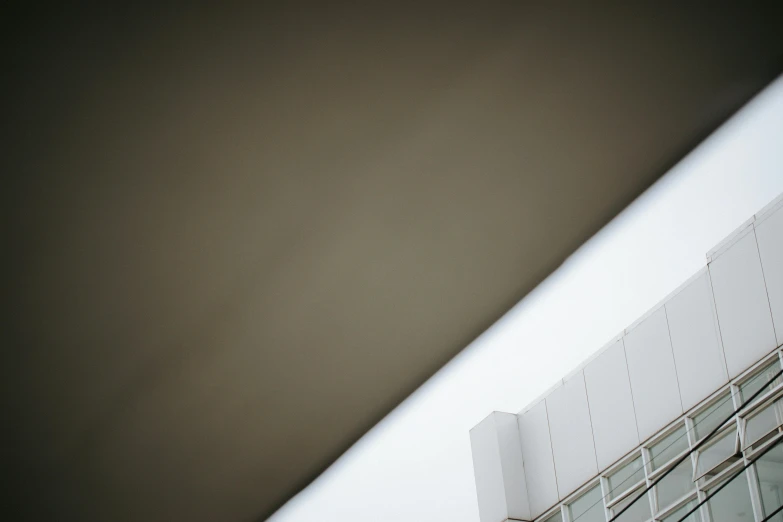 a clock that is on the side of a building, a picture, inspired by Andreas Gursky, unsplash, brutalism, gradient brown to white, shooting angle from below, square jaw-line, shot on sony alpha dslr-a300