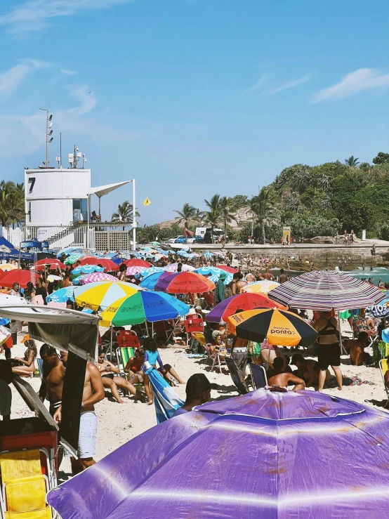 a crowd of people sitting on top of a sandy beach, umbrellas, farol da barra, where's wally, instagram story